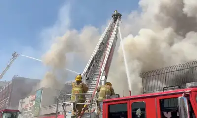 Nearly 100 firefighters battle large fire burning at downtown Los Angeles commercial building